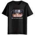 A black short-sleeve crewneck t-shirt featuring a graphic print of the anime character Itachi Uchiha with his red Sharingan eyes and the text 'We Live Inside Illusion.' printed below.